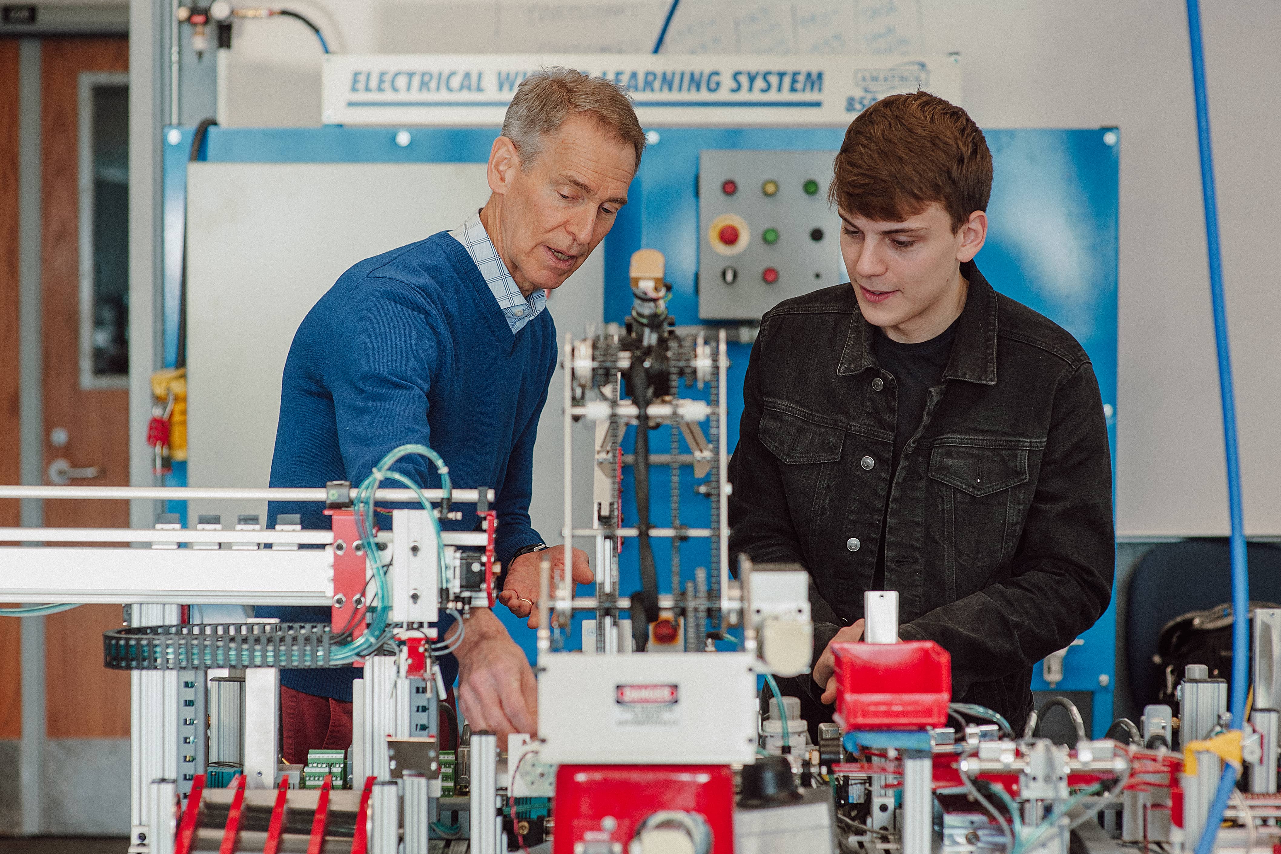 Professor and student in front of smart factory