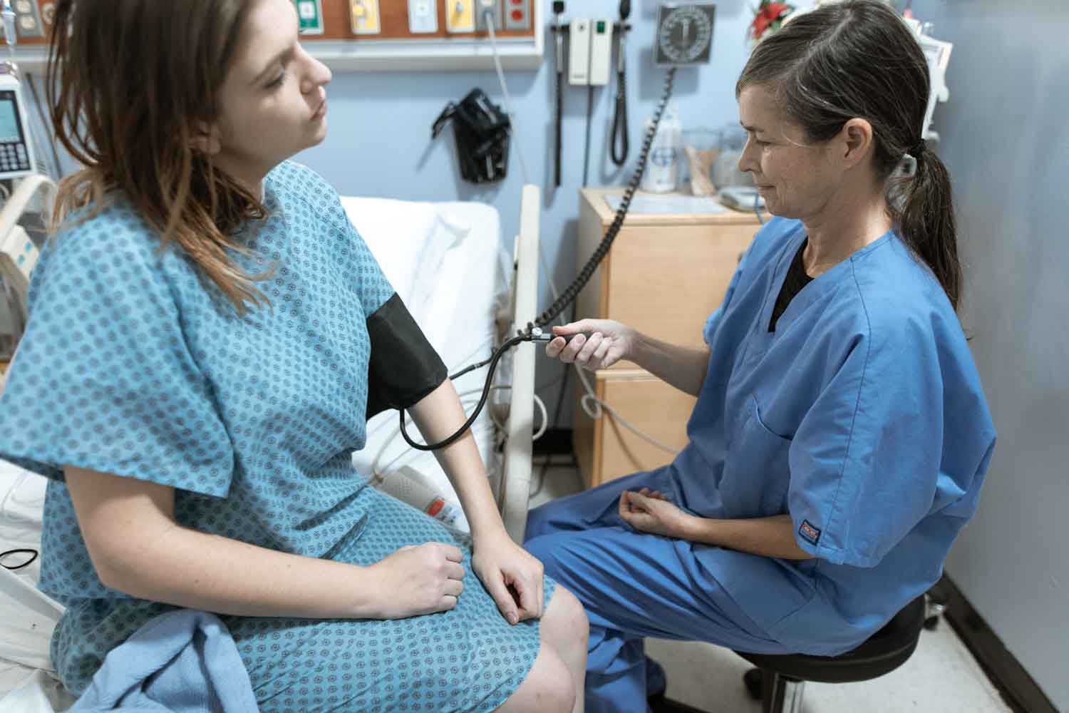 person taking blood pressure of a patient