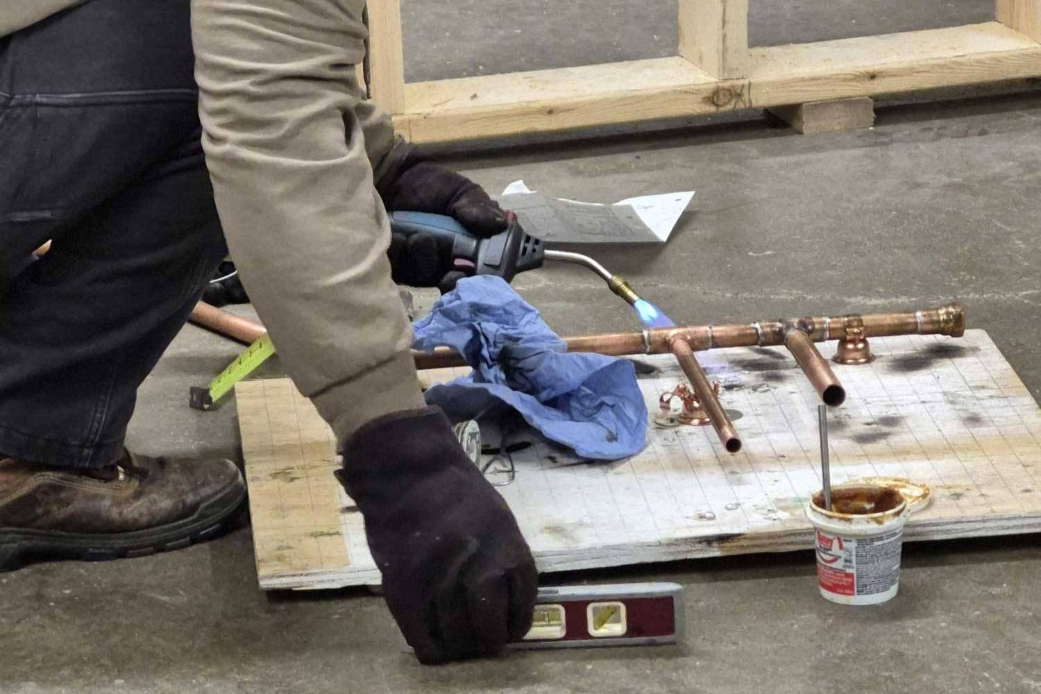 person fitting a pipe