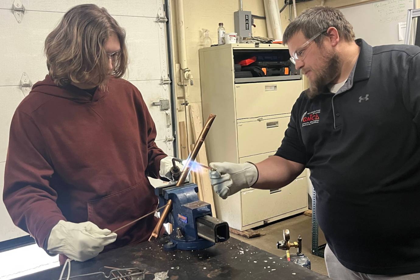 Student learning pipe brazing in an HVAC lab