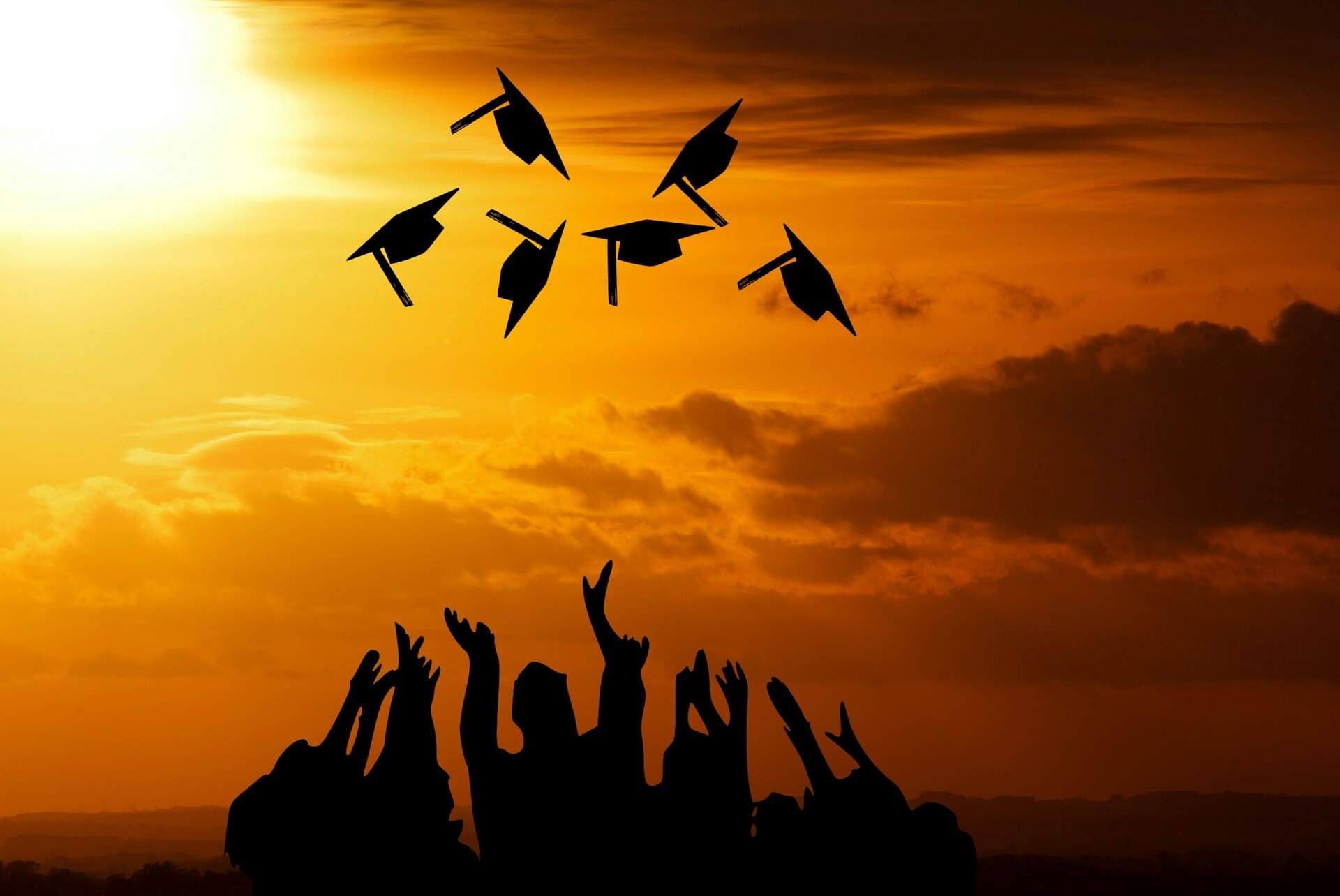 Graduates throwing caps in air