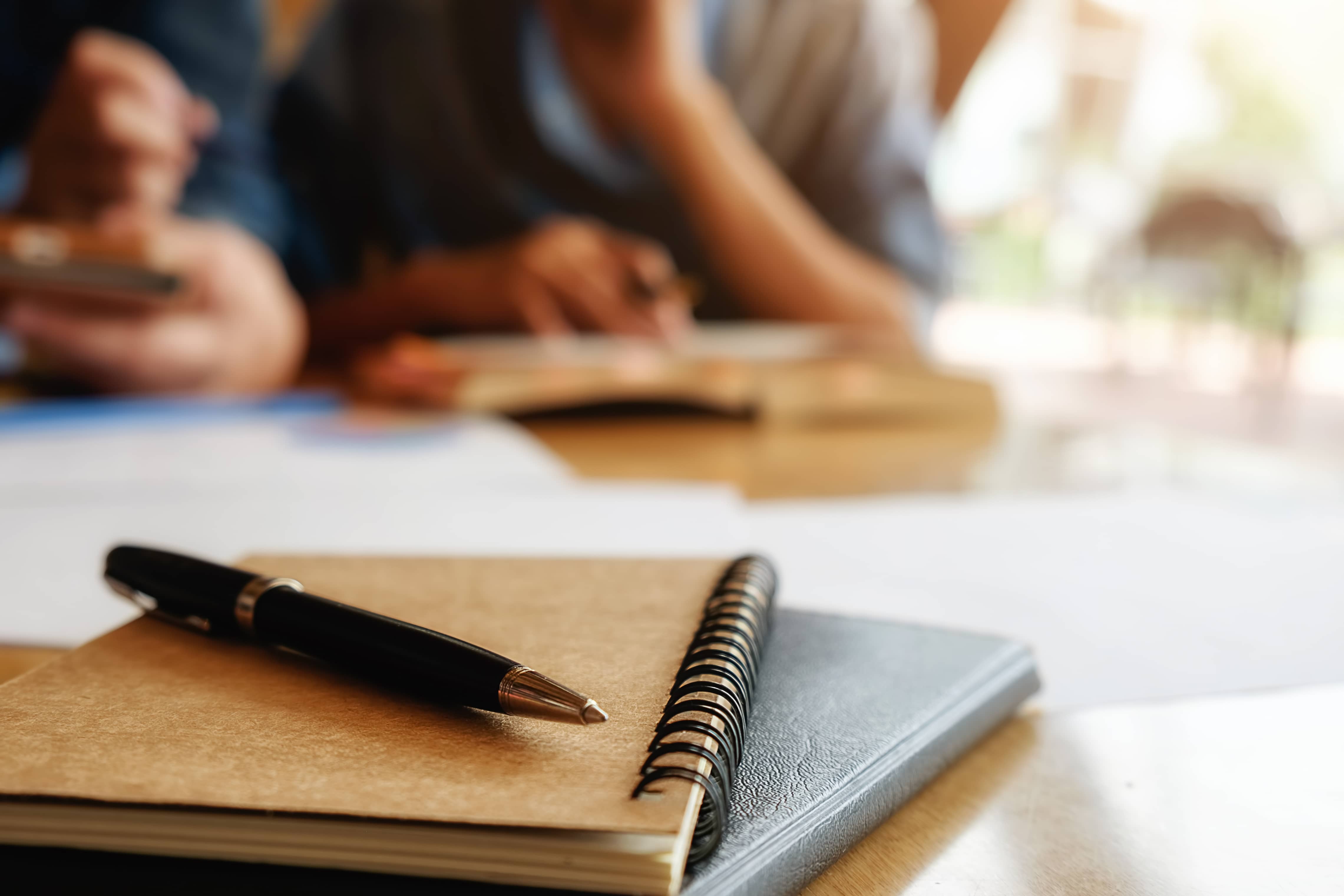 Notebooks in front of students