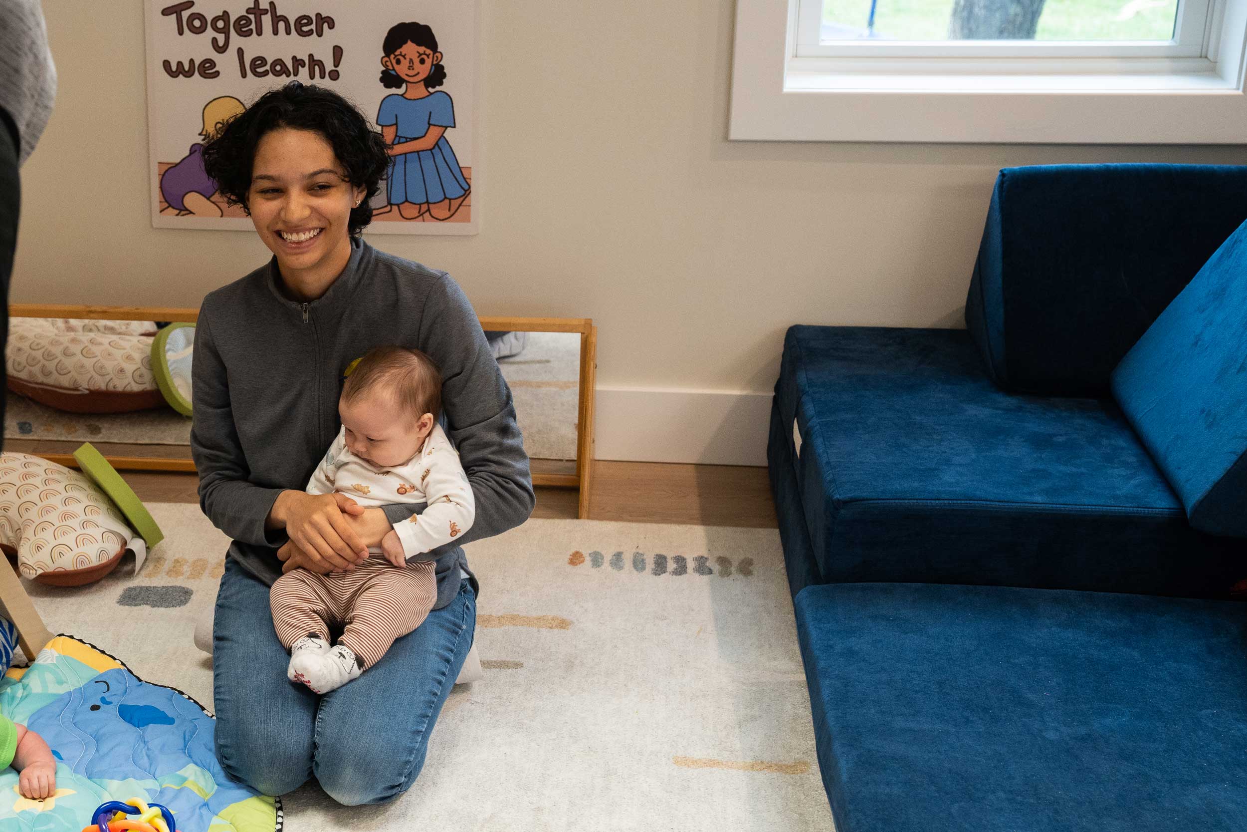 childcare staff holding a baby