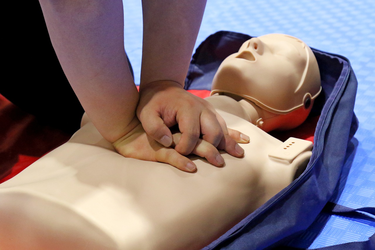 Closeup of hands giving CPR on dummy