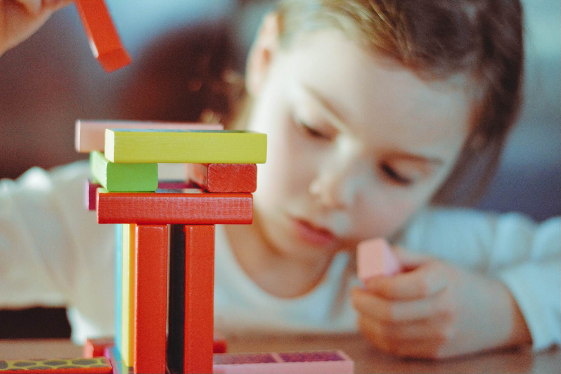 child stacking blocks