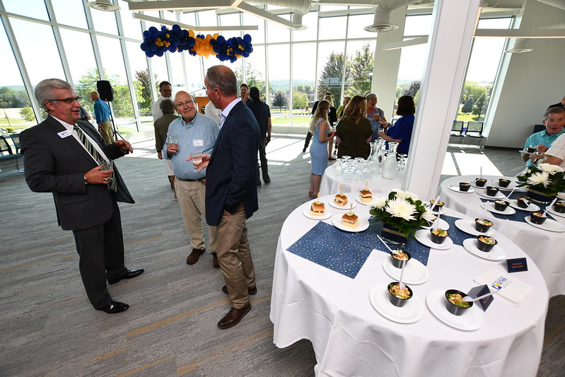 people at an event with food and drinks