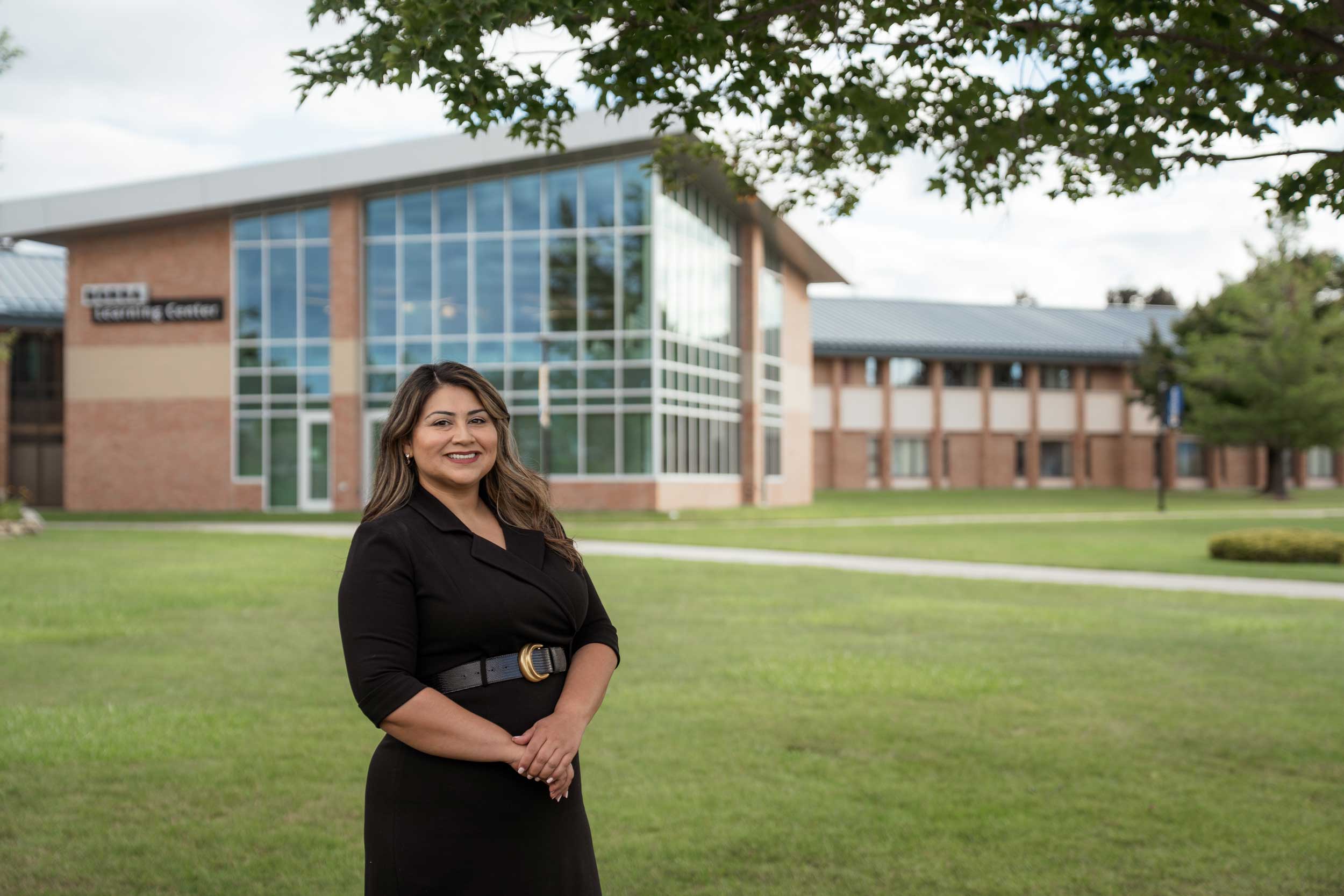 North Central Michigan College Dean of Workforce and Continuing Education Cassandra Hernandez stands outside the Borra Learning Center on the Petoskey campus.