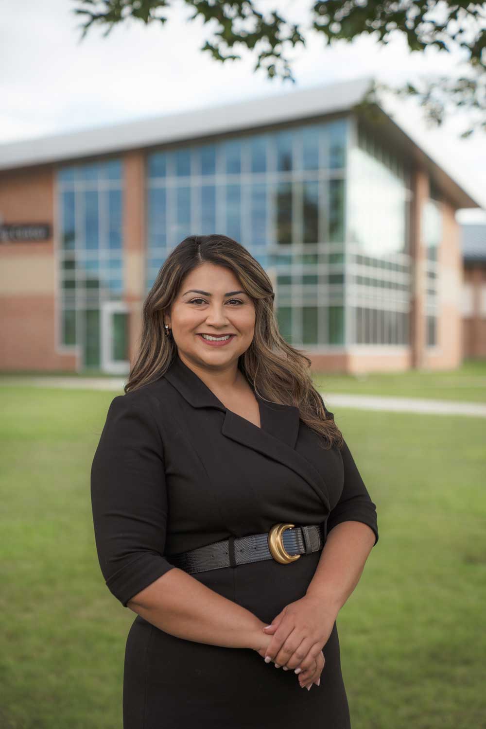 Cassandra Hernandez, North Central Michigan College Dean of Workforce and Continuing Education, smiles outside the Borra Learning Center on the Petoskey campus.