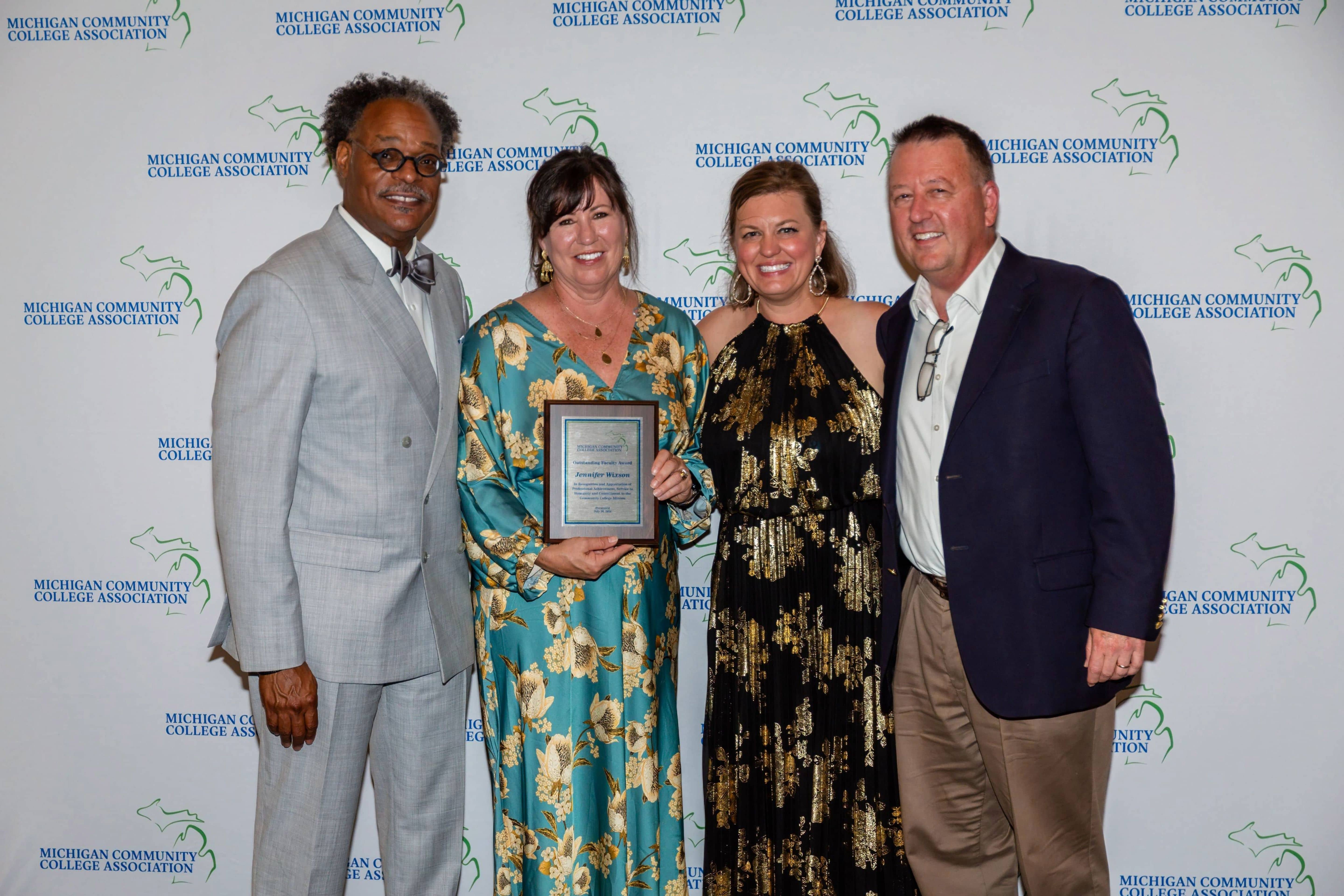 Jennifer Wixson accepts the 2026 Michigan Community College Association Outstanding Faculty Award during the MCCA Summer Conference on Mackinac Island, joined by MCCA and North Central Michigan College leaders.