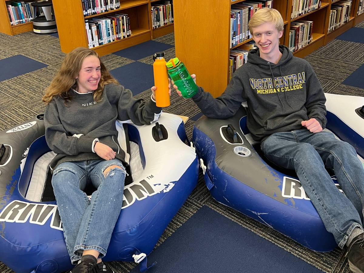 Students posing with inflatable tubes