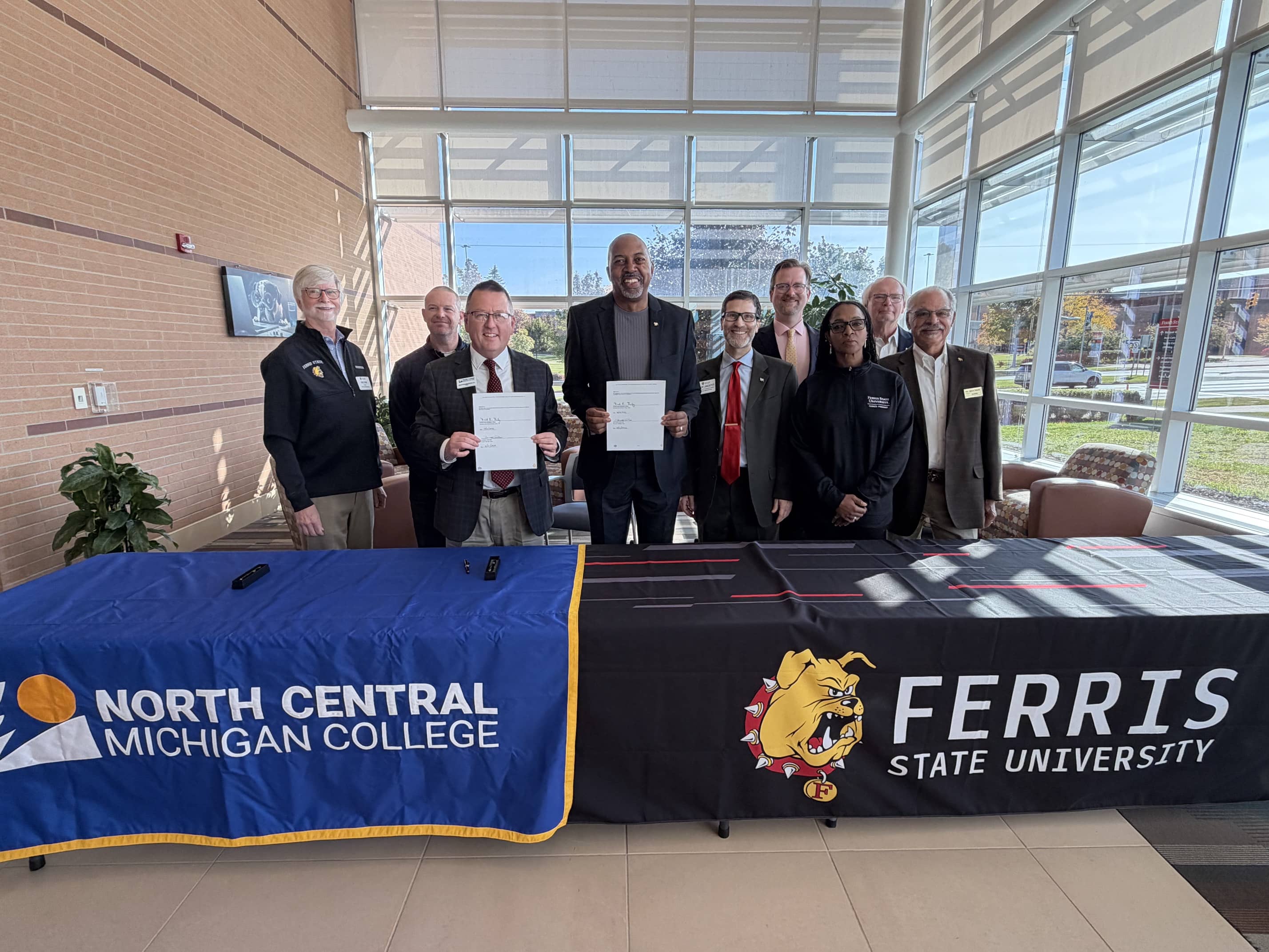 Officials from North Central Michigan College and Ferris State University pose for a group photo during an Oct. 10 meeting to formalize new transfer pathways in pharmacy and optometry.