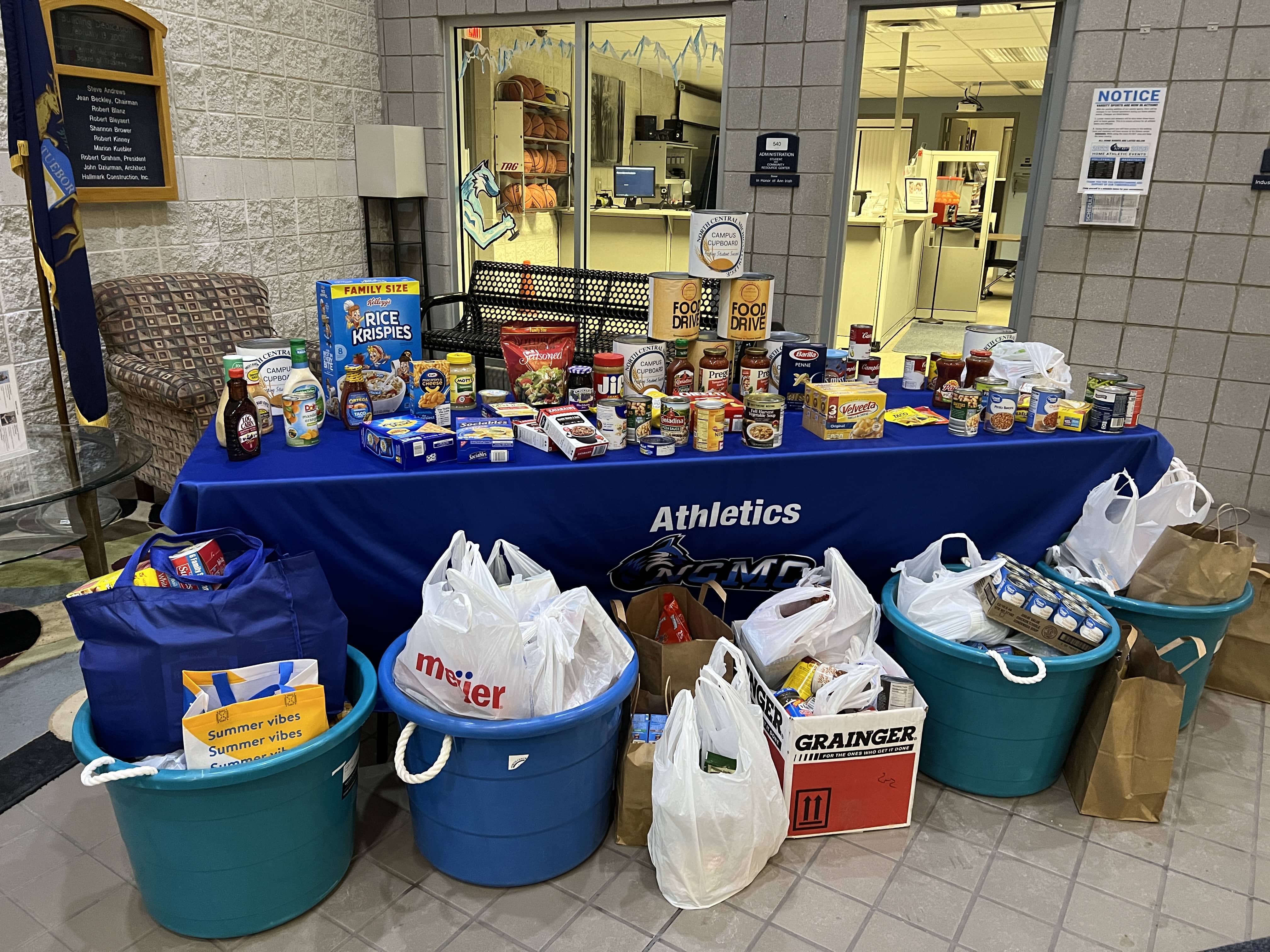 Canned food donations on and surrounding a table