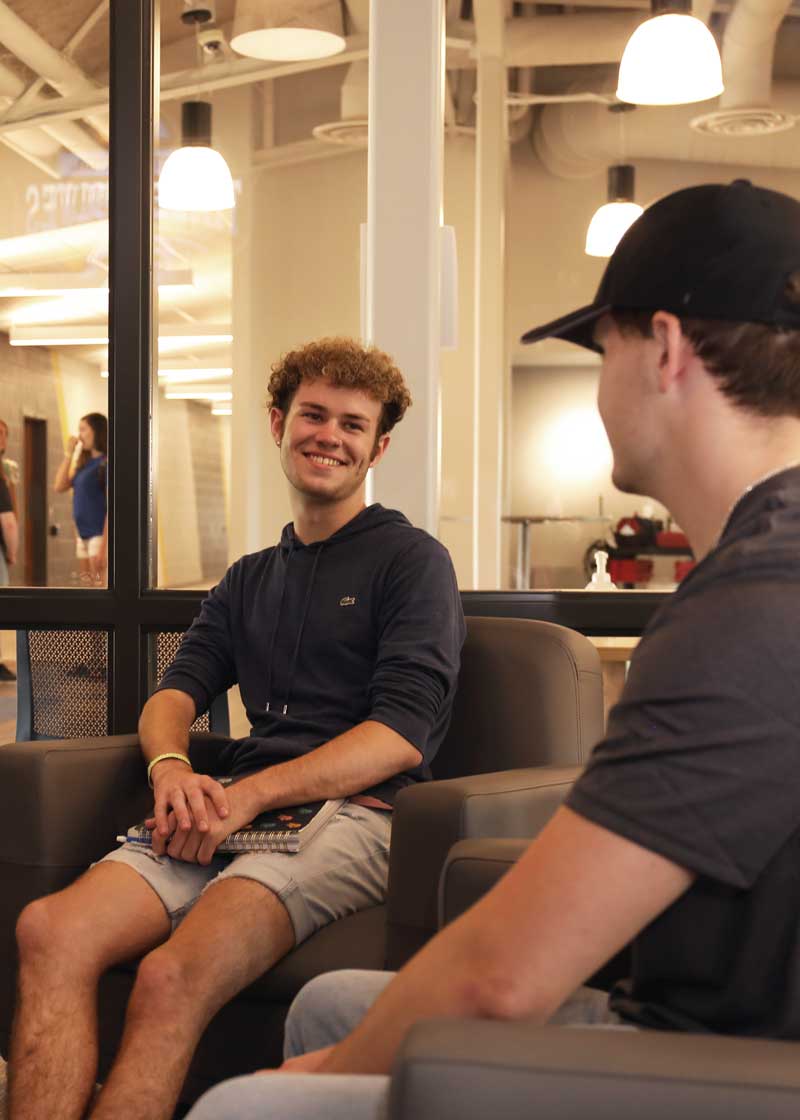 Students smiling in orientation meeting.