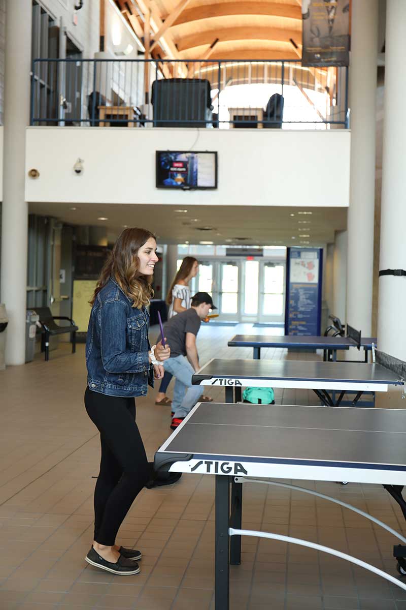 Students playing ping pong.