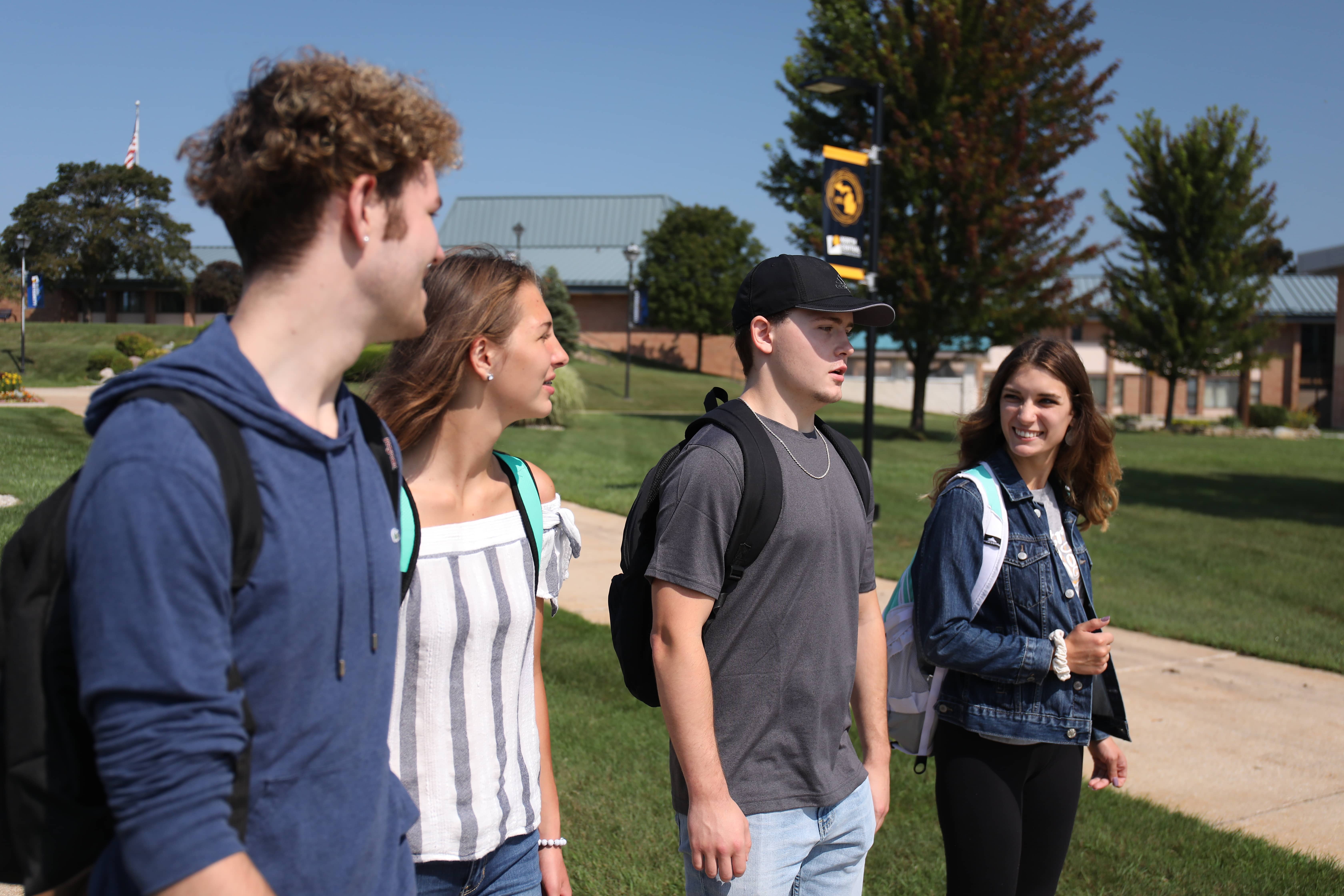 Four students walking on campus