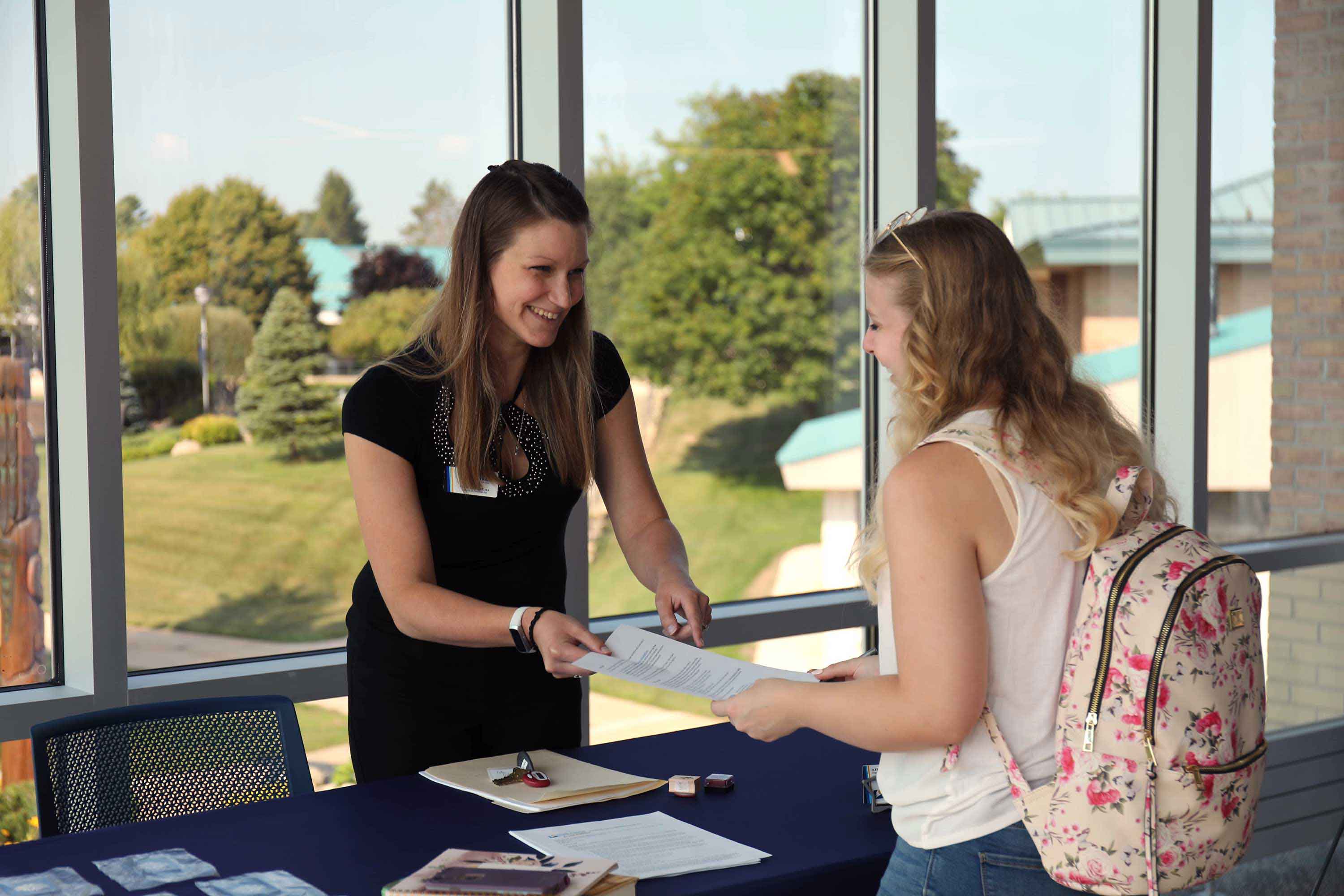 Financial Aid professional interacting with student